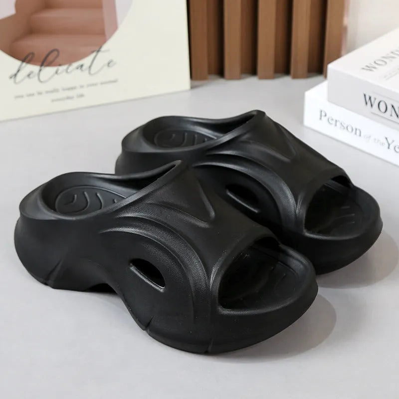 Women's thick-soled EVA foam beach slippers in rose red colour on a sandy background.