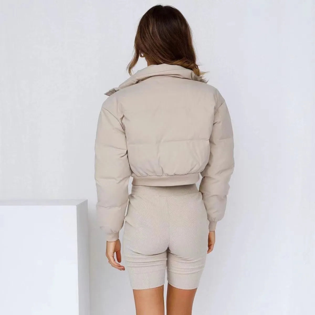 Women's loose-fit long sleeve polyester jacket in blue on a hanger.