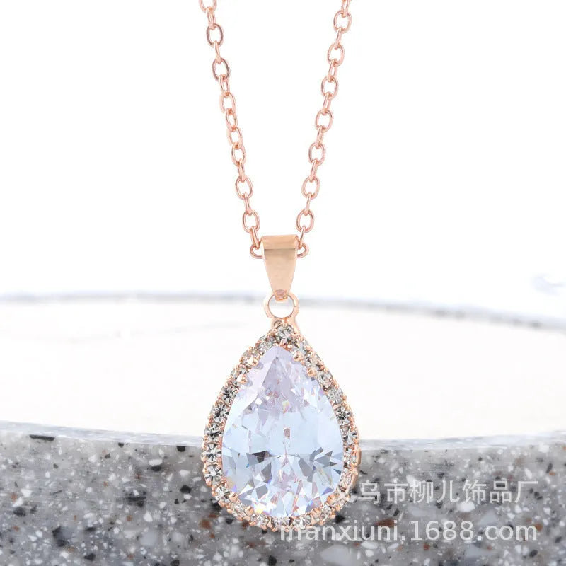 Rose gold geometric water drop pendant necklace on a model, showing adjustable chain and sparkling stone inlay.