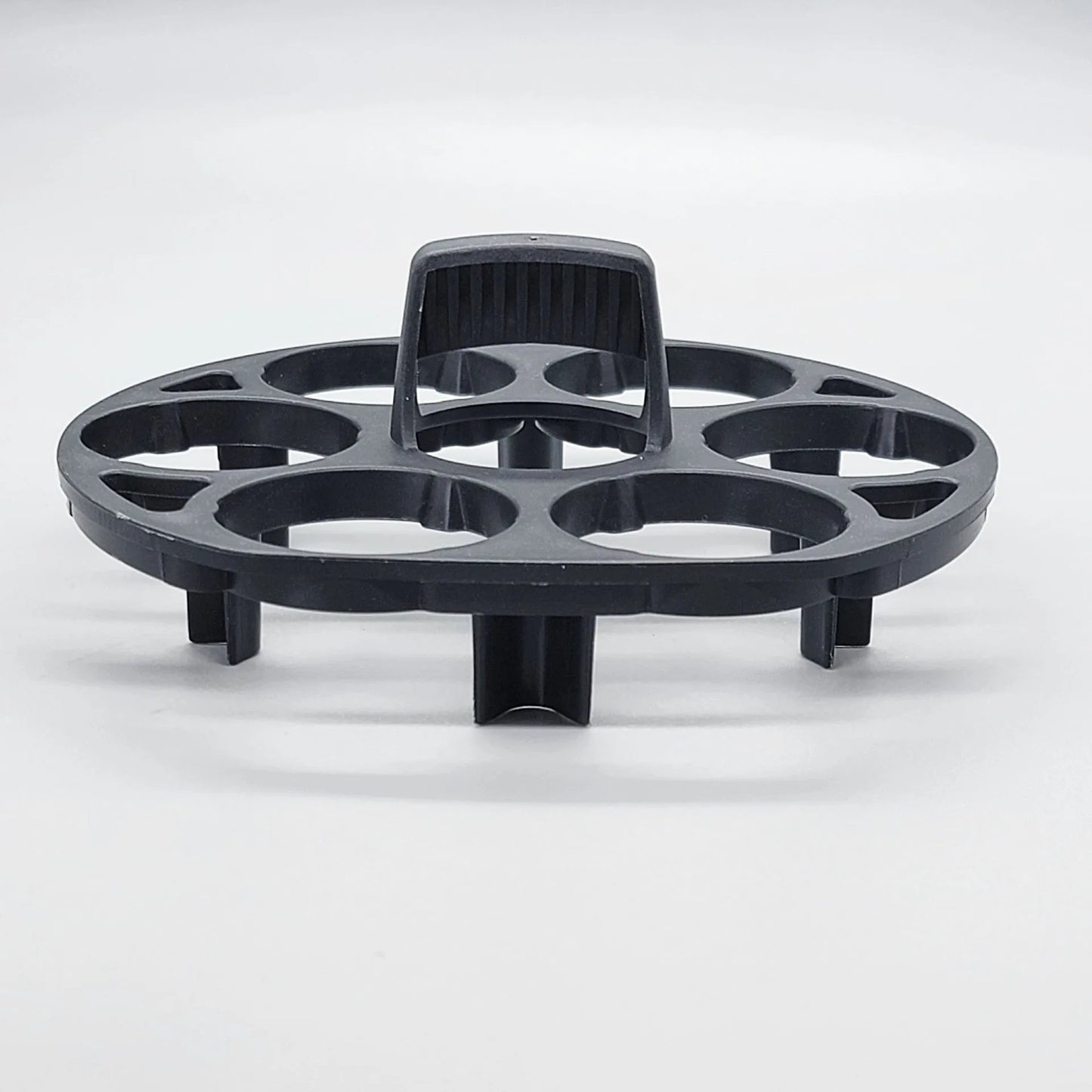 Black plastic egg holder rack for a cooking machine, shown from above.