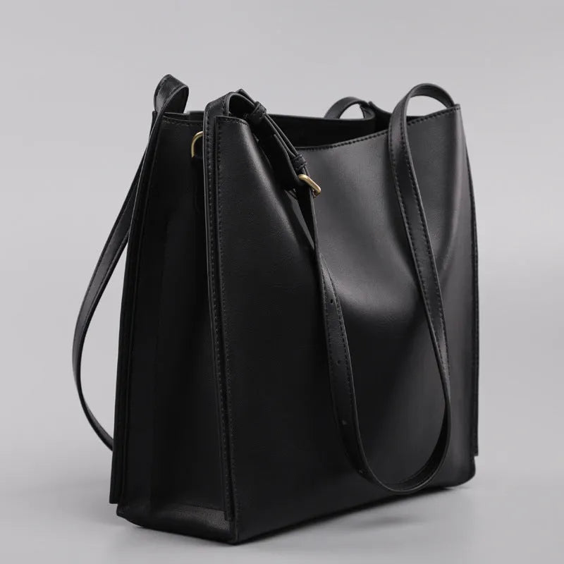 Brown genuine leather women's bucket bag with double shoulder straps showing organisational compartments