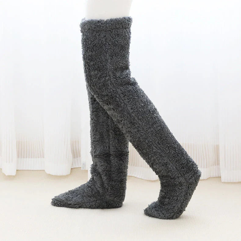 Cozy over-the-knee fuzzy socks in various colors, including brown, blue, dark gray, pink, silver, and more. Comfortable cotton design for warm, snug legs.
