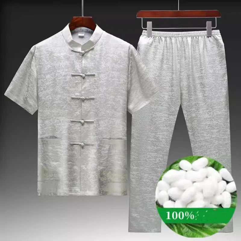 Traditional light green mulberry silk Tang suit for men on a hanger.