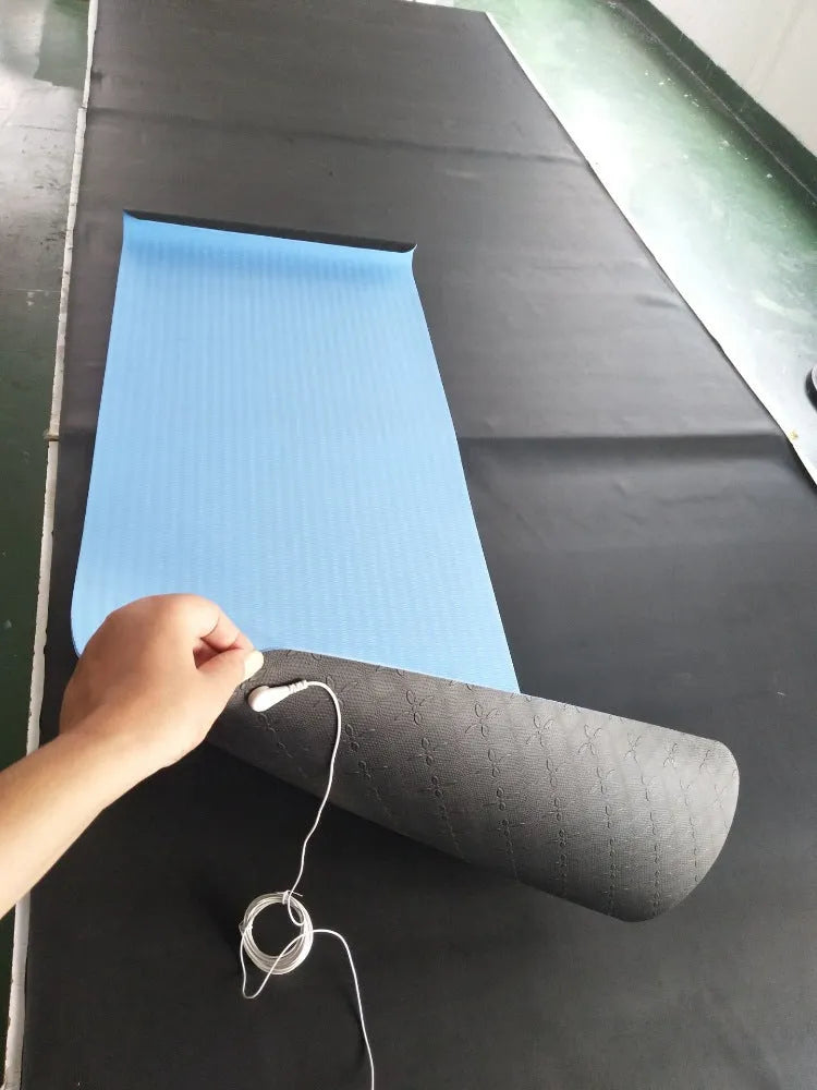 Blue conductive grounding yoga mat with botanical print, showing attached wire and rolled edge, dimensions 182cm by 61cm.