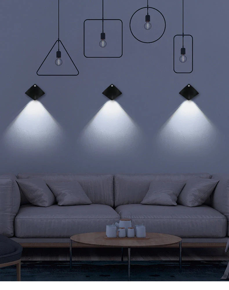 Wireless motion-activated wall lamp with USB recharging, available in black or white finish