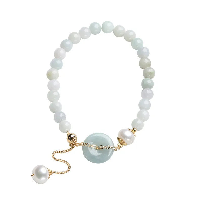 A geometric jade and pearl bracelet for women with a hand-finished peace buckle pendant.