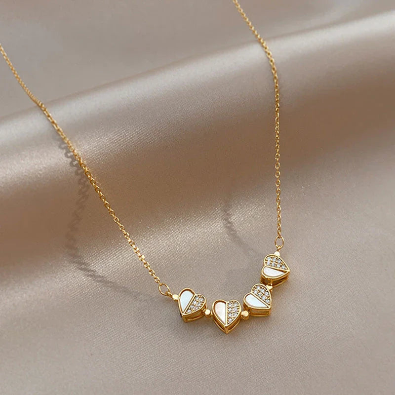 Elegant four-leaf clover pendant necklace with sparkling crystal heart detail, made of premium stainless steel for women's fashion jewelry gift