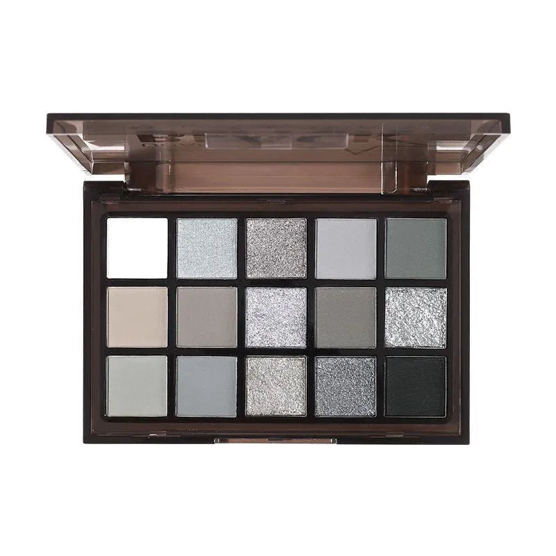 Open 15-colour eyeshadow palette showing shimmer and matte pans in browns, blues, and earth tones