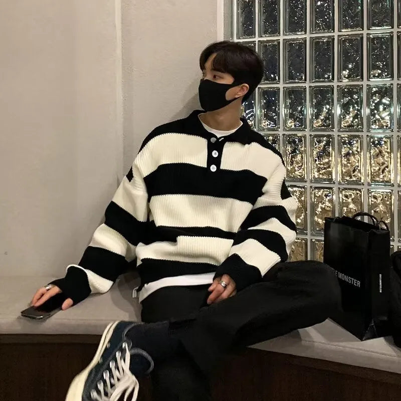 Man wearing a loose-fit black and grey striped polyester pullover sweater
