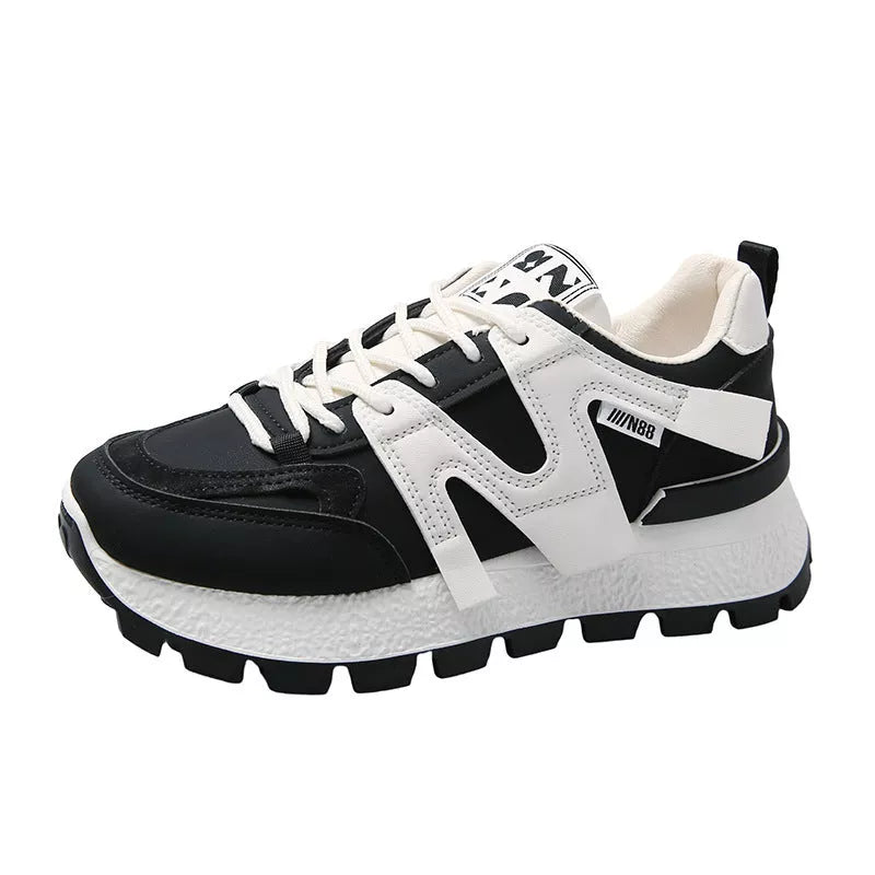 Women's low-top running sneaker in white or black with rubber sole