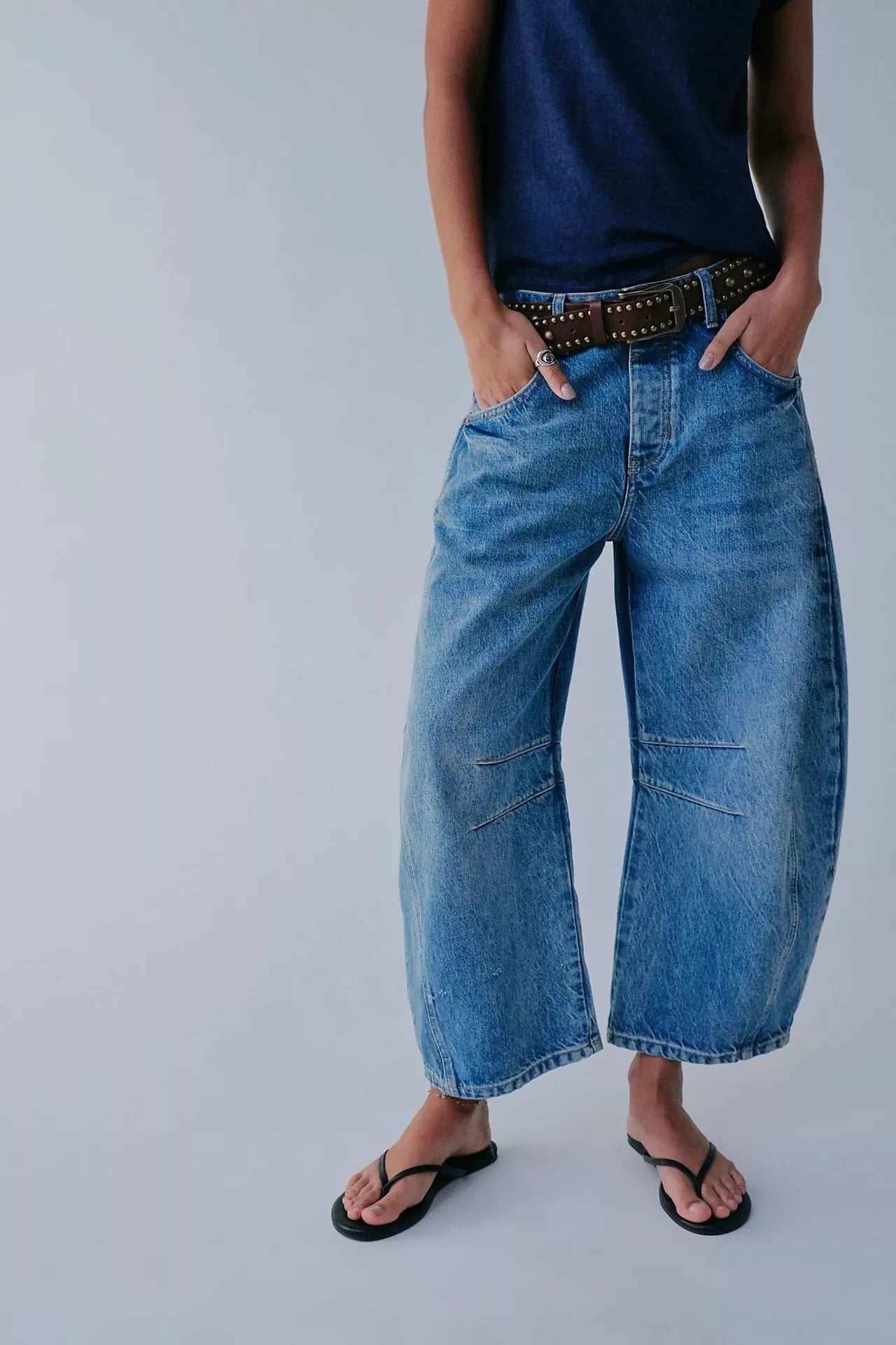 Women's mid-rise barrel jeans with wide leg design in various colors