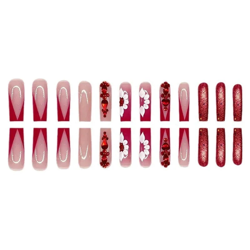 Sweet floral pattern press-on nails with red diamond accents in a long European Square shape.