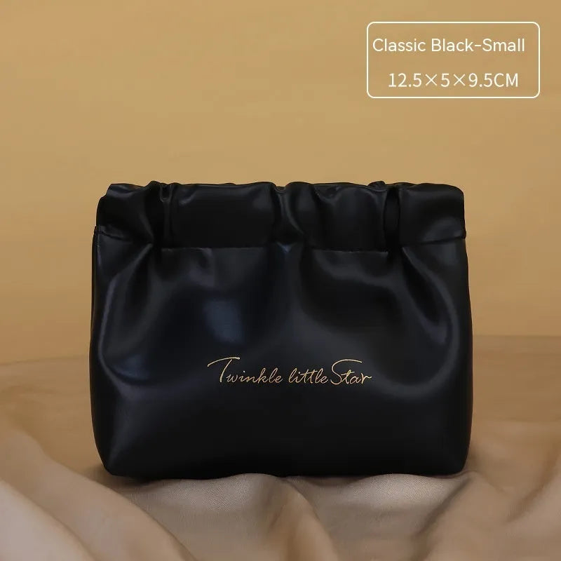 Leather travel toiletry bag with dry-wet separation compartments in caramel mocha colour with letter detailing