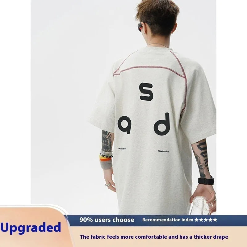 Black loose fit cotton T-shirt with white letter print on front, short sleeves and round neck.