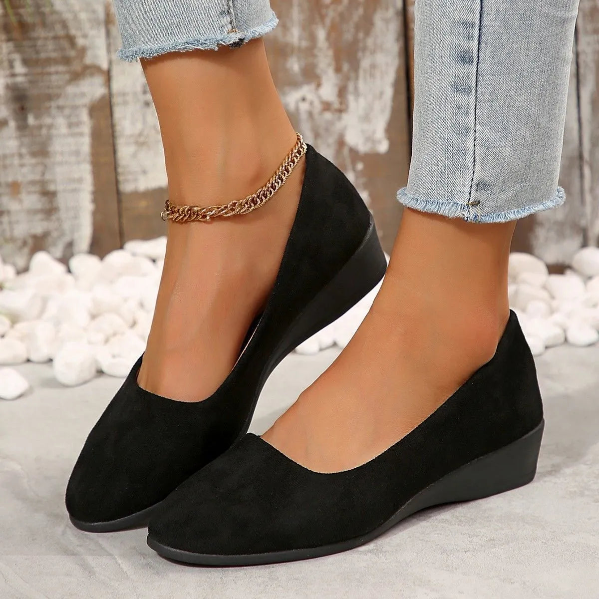 Women's black pointed toe wedge pumps with suede upper and low rubber sole
