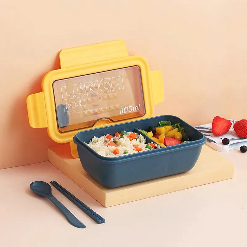 Green four-compartment plastic bento box with secure lid, showing internal partitions for separate food storage.