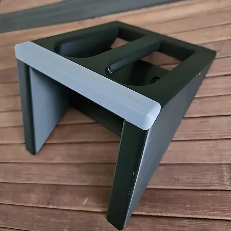 Matte black plastic punk-style pistol display stand on a wooden surface, measuring 10.85cm long.