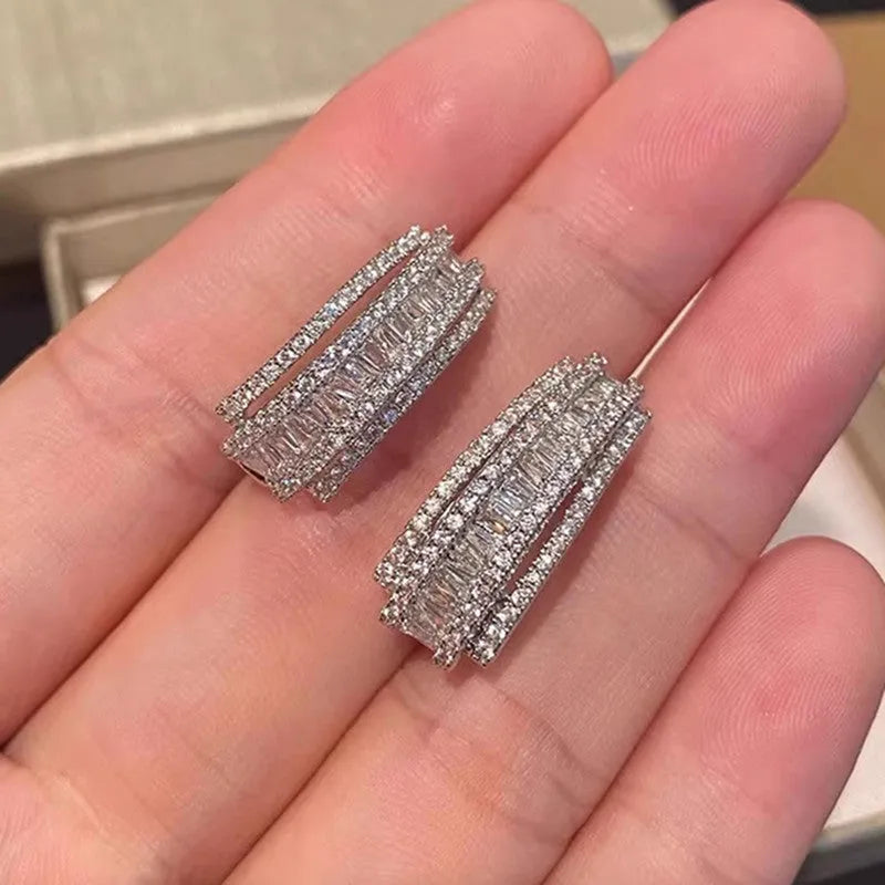 Women's white gold geometry stud earrings with inlaid zircon detail on copper.