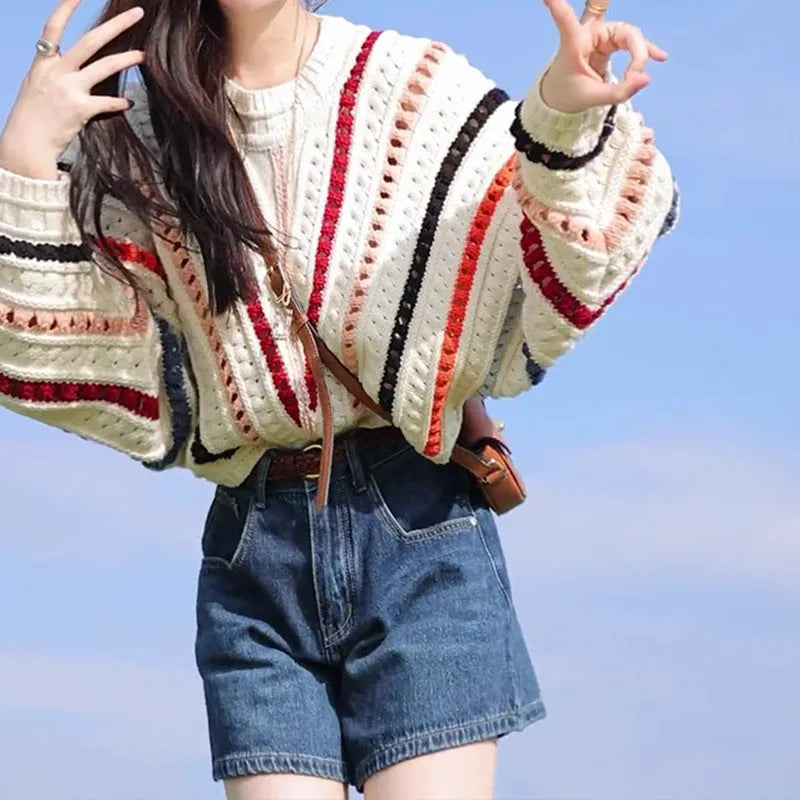 Rainbow striped batwing sleeve hollow knit sweater with round neck, shown in loose fit on model