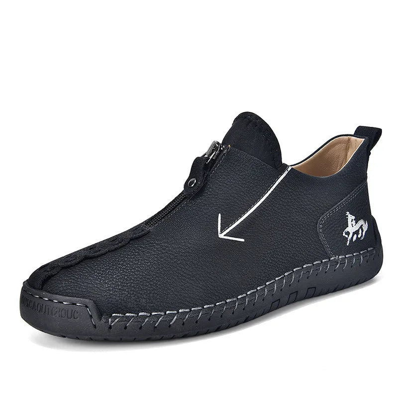 Men's black leather boots with front zipper, hand-stitched detailing, and rubber sole on a neutral background
