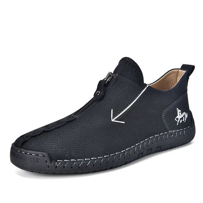 Men's black leather boots with front zipper, hand-stitched detailing, and rubber sole on a neutral background