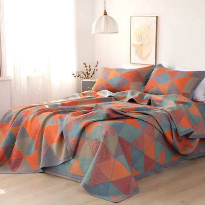 Three-piece cotton gauze bed set with floral print, showing blanket and pillowcases on a bed.