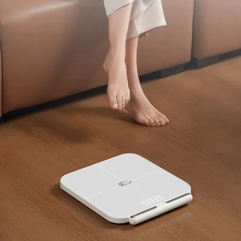 White professional body fat scale with 8 electrodes, LED display, and USB charging port on tempered glass surface