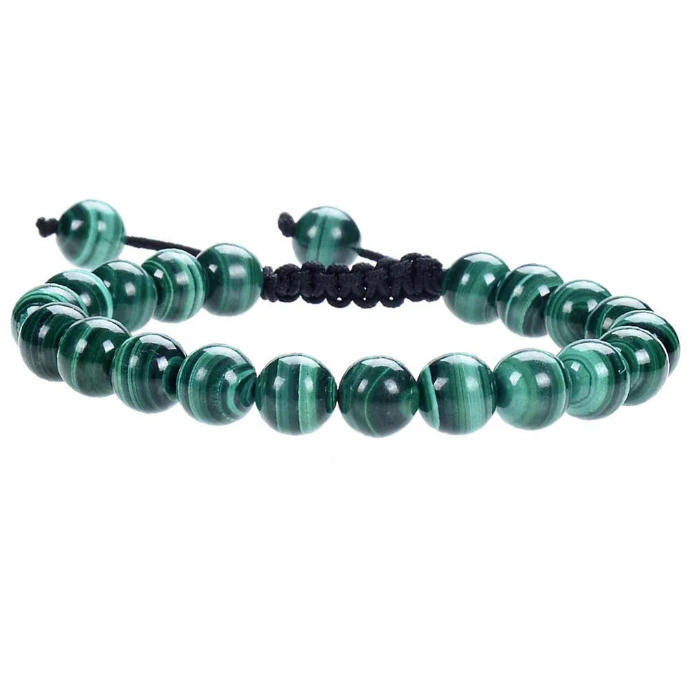 Close-up of a women's flat knot braided healing bracelet hand-woven with colourful gemstones.