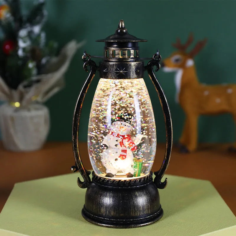 Crystal ball Christmas decoration with LED-lit paper snowman and elderly figures on desktop