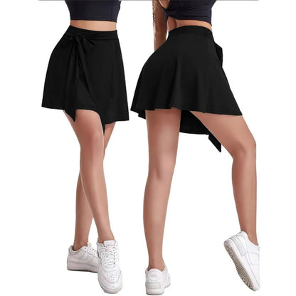 Black thigh-length sports skirt with high waist and attached shorts, showing shoulder strap detail.