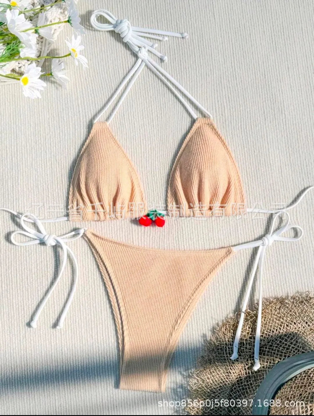 Solid colour briefs-style bikini swimsuit on a hanger, showing the top and pants.