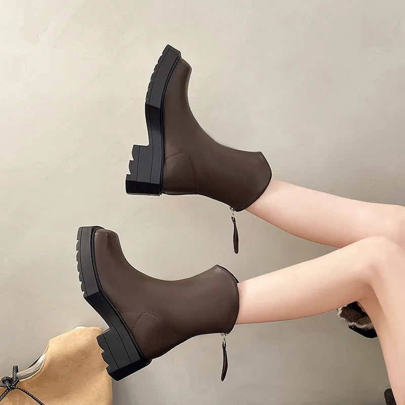 Women's black platform Martin ankle boots with square toe and back zip on a white background.