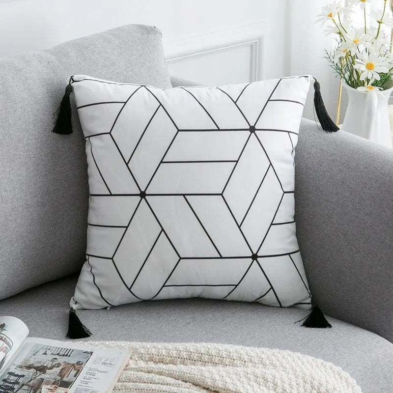 Bohemian style decorative pillowcase in light grey colour on a sofa.