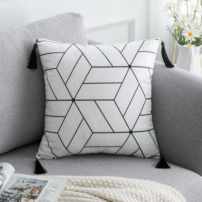 Bohemian style decorative pillowcase in light grey colour on a sofa.