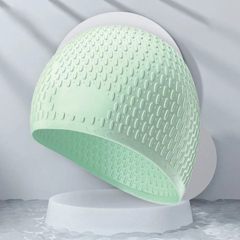 Silicone water drop swimming cap for adults shown in one of nine solid colours.