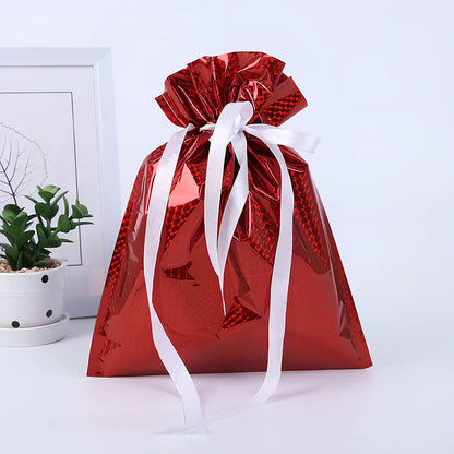 Christmas gift bag with drawstring closure in laser gold finish, 32x24cm dimensions