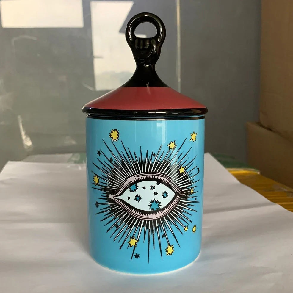 Blue ceramic candle holder with figure decals measuring 15cm high