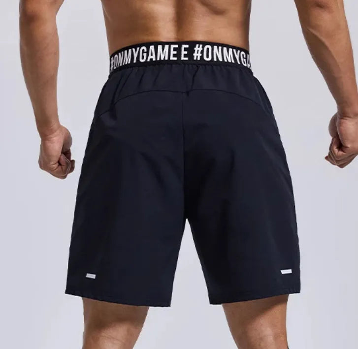 Men's loose grey sports shorts with elastic waistband and letter detail, shown front and back.