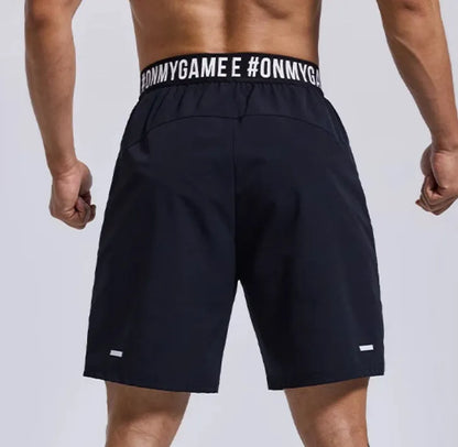 Men's loose grey sports shorts with elastic waistband and letter detail, shown front and back.