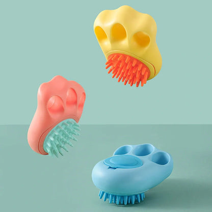 Claw-shaped pet grooming brush in pink, blue, yellow, and grey