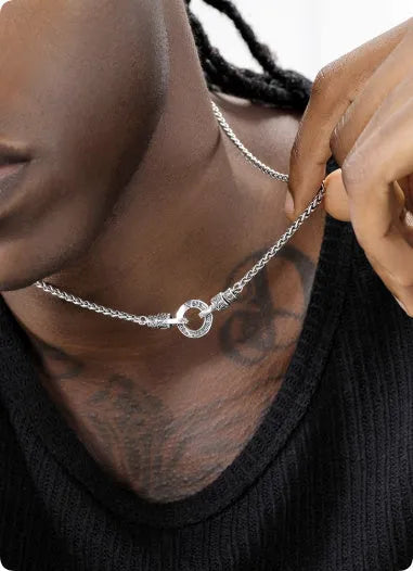 Simple polished S925 sterling silver chain necklace on a dark background, showing its length and clasp.