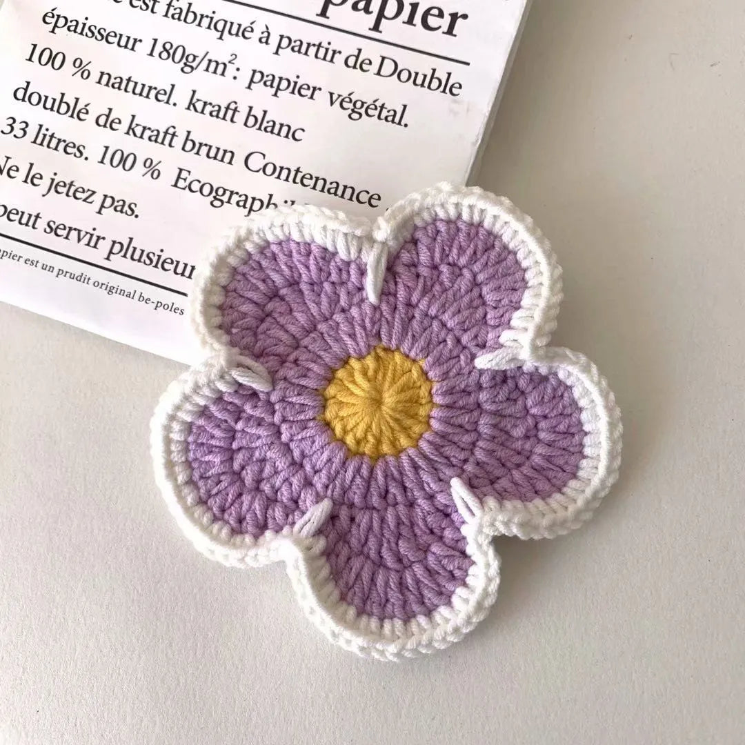 Five handmade woven flower placemats in blue, green, orange, pink and purple colours