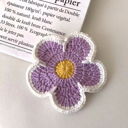 Five handmade woven flower placemats in blue, green, orange, pink and purple colours