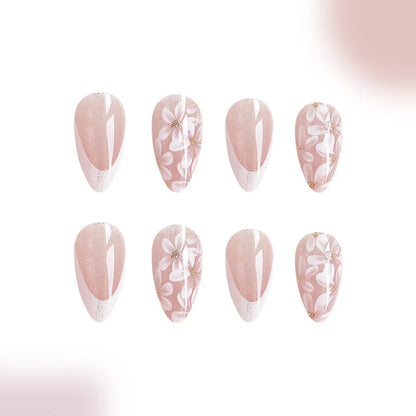 Short glossy almond artificial French nails with glitter flower design on white tips