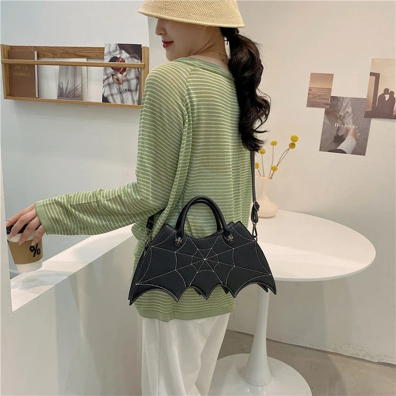 Stylish Halloween spider web crossbody bag in various colors, including black, white, brown, pink, and purple
