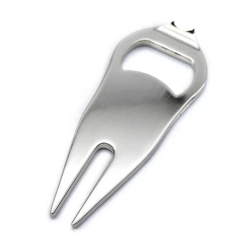 A black zinc alloy golf ball yoke tool with a bottle opener and a separate ball coin on a putting green.