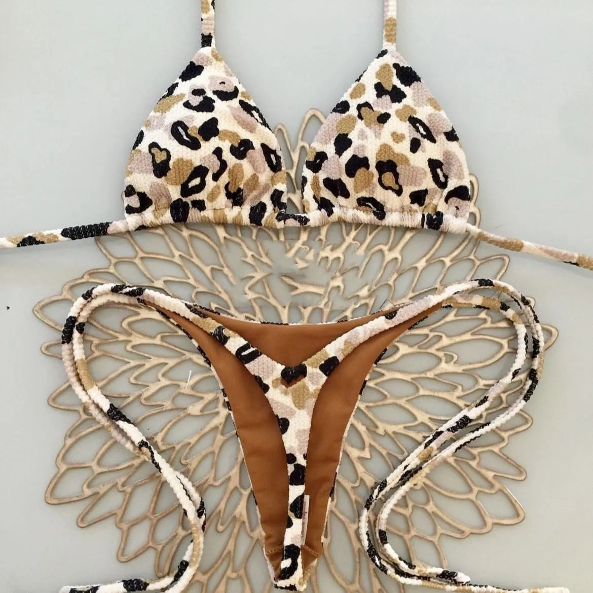 Women's printed bikini swimsuit with briefs style and cotton lining on a mannequin.