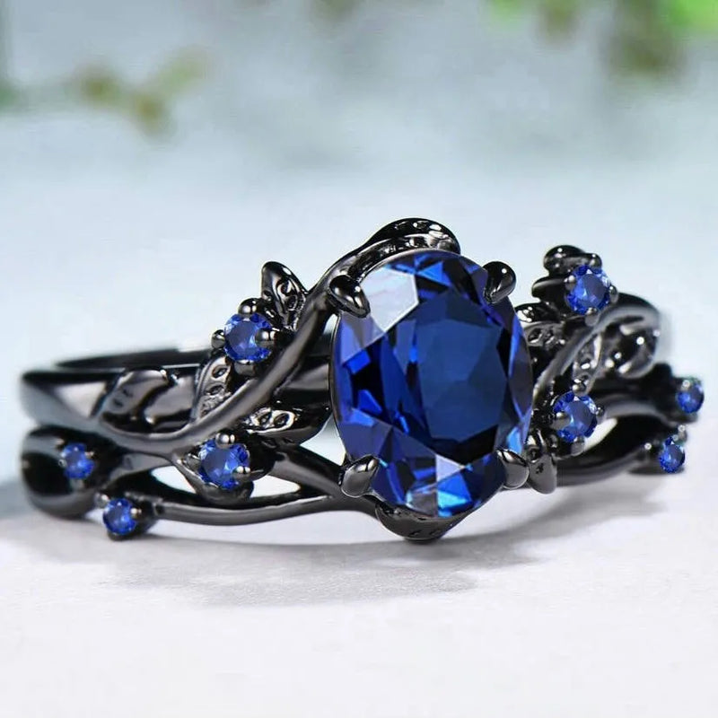 Couple rings electroplated gun black with inlaid navy blue rhinestones and geometric shape in sizes 6 to 10 for female wearers seeking a distinctive jewellery ornament for matching or personal style