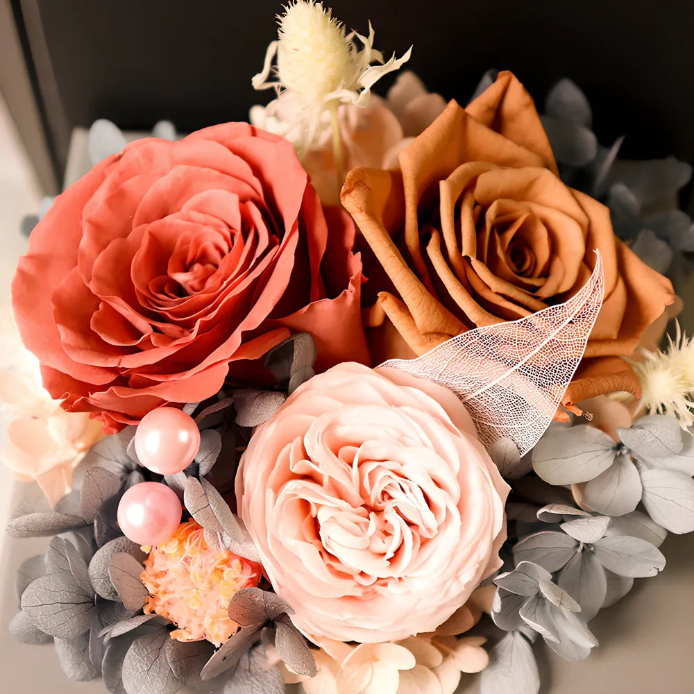 Preserved eternal flower gift box with roses, carnations, and hydrangea in red and pink colours