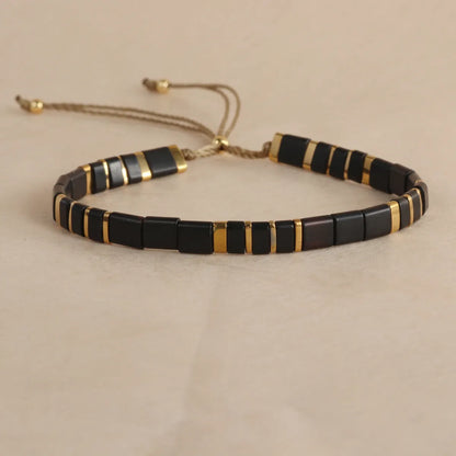 Adjustable pull beads glass bracelet in geometric shapes, shown in milky white colour.